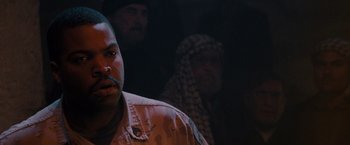 Movie still from “Three Kings” (1999), directed by David O. Russell – A man in fatigues is looking into the camera; Close Up shot, Over the shoulder angle