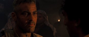 Movie still from “Three Kings” (1999), directed by David O. Russell – A person wearing a hat; Close Up shot, Over the shoulder angle