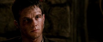 Movie still from “Three Kings” (1999), directed by David O. Russell – A man's face in a dark room; Close Up shot, Over the shoulder angle