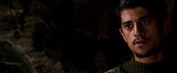 Movie still from “Three Kings” (1999), directed by David O. Russell – A man in a military uniform smiling for the camera; Close Up shot, Over the shoulder angle