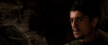 Movie still from “Three Kings” (1999), directed by David O. Russell – A person in a dark room; Close Up shot, Over the shoulder angle