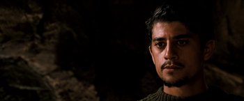 Movie still from “Three Kings” (1999), directed by David O. Russell – A person wearing a sweater; Close Up shot, Low angle