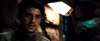 Movie still from “Three Kings” (1999), directed by David O. Russell – A person wearing a hat; Close Up shot, Over the shoulder angle