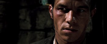 Movie still from “Three Kings” (1999), directed by David O. Russell – A person wearing ear phones; Close Up shot, High angle