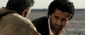 Movie still from “Three Kings” (1999), directed by David O. Russell – A man in a black jacket is talking to another man; Close Up shot, Over the shoulder angle