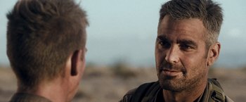 Movie still from “Three Kings” (1999), directed by David O. Russell – Two men are talking in the desert; Close Up shot, Over the shoulder angle