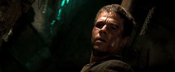 Movie still from “Three Kings” (1999), directed by David O. Russell – A person wearing a suit and tie; Close Up shot, Low angle