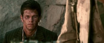 Movie still from “Three Kings” (1999), directed by David O. Russell – A person wearing a suit and tie; Close Up shot, Low angle