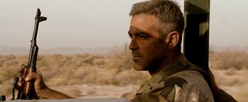 Movie still from “Three Kings” (1999), directed by David O. Russell – A person wearing a military uniform; Close Up shot, Over the shoulder angle