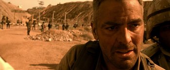 Movie still from “Three Kings” (1999), directed by David O. Russell – A person in a field; Close Up shot, Low angle