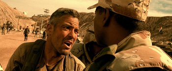 Movie still from “Three Kings” (1999), directed by David O. Russell – A man in a military uniform talking to another man in fatigues; Close Up shot, Low angle