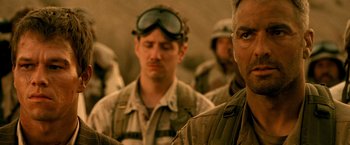 Movie still from “Three Kings” (1999), directed by David O. Russell – A group of men standing next to each other in the desert; Close Up shot, Low angle