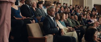 Movie still from “Ticket to Paradise” (2022), directed by Ol Parker – A group of people sitting in a room; Wide shot, High angle