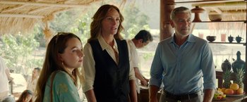 Movie still from “Ticket to Paradise” (2022), directed by Ol Parker – A group of people standing next to each other; Medium shot, Over the shoulder angle