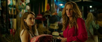 Movie still from “Ticket to Paradise” (2022), directed by Ol Parker – Two women sitting next to each other in a room; Close Up shot, Over the shoulder angle