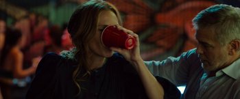 Movie still from “Ticket to Paradise” (2022), directed by Ol Parker – A woman is drinking a red cup of coffee; Close Up shot, Over the shoulder angle