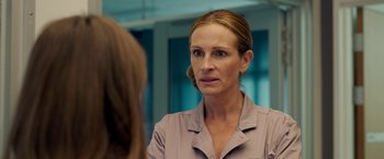 Movie still from “Ticket to Paradise” (2022), directed by Ol Parker – A woman looking at herself in the mirror; Close Up shot, Over the shoulder angle