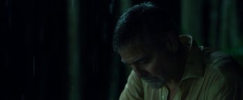 Movie still from “Ticket to Paradise” (2022), directed by Ol Parker – A person sitting down with his head down; Close Up shot, Low angle