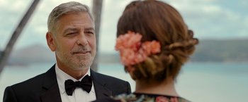 Movie still from “Ticket to Paradise” (2022), directed by Ol Parker – A man and a woman in formal wear talking to each other; Close Up shot, Over the shoulder angle