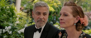 Movie still from “Ticket to Paradise” (2022), directed by Ol Parker – A man and a woman in a suit and bow tie; Close Up shot, Over the shoulder angle