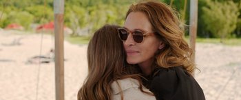 Movie still from “Ticket to Paradise” (2022), directed by Ol Parker – A person hugging another person; Close Up shot, Over the shoulder angle