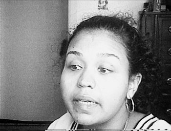 Movie still from “Time” (2020), directed by Garrett Bradley – A black - and - white photo of a young woman's face; Close Up shot, High angle