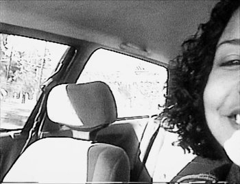 Movie still from “Time” (2020), directed by Garrett Bradley – A black and white photo of a person in a car; Close Up shot, High angle