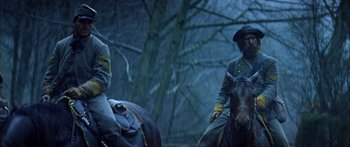 Movie still from “Timecop” (1994), directed by Peter Hyams – Two civil war soldiers on horseback in a wooded area; Medium shot, Low angle