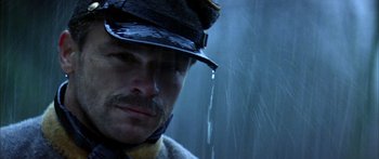 Movie still from “Timecop” (1994), directed by Peter Hyams – A person wearing a hat; Close Up shot, Low angle