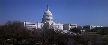Movie still from “Timecop” (1994), directed by Peter Hyams – A view of the united states capitol building from across the street; Extreme Wide shot, Low angle