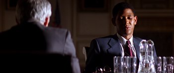 Movie still from “Timecop” (1994), directed by Peter Hyams – A man sitting at a table in front of a woman; Close Up shot, Low angle