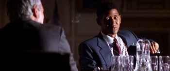 Movie still from “Timecop” (1994), directed by Peter Hyams – A man in a suit and tie smoking a cigarette; Close Up shot, Low angle