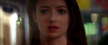 Movie still from “Timecop” (1994), directed by Peter Hyams – A woman's face in a dark room; Close Up shot, Low angle