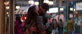 Movie still from “Timecop” (1994), directed by Peter Hyams – A man and a woman kissing in the street at night; Medium shot, Low angle