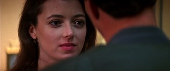 Movie still from “Timecop” (1994), directed by Peter Hyams – A person looking at a person; Close Up shot, Over the shoulder angle