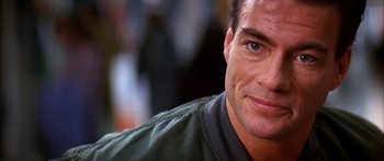 Movie still from “Timecop” (1994), directed by Peter Hyams – Close up of a man's face in a green jacket; Close Up shot, Over the shoulder angle