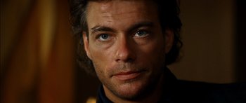 Movie still from “Timecop” (1994), directed by Peter Hyams – A man's face with blue eyes; Close Up shot, Low angle