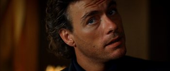 Movie still from “Timecop” (1994), directed by Peter Hyams – A man's face with blue eyes; Close Up shot, Over the shoulder angle