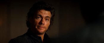 Movie still from “Timecop” (1994), directed by Peter Hyams – A person wearing a black shirt; Close Up shot, Over the shoulder angle