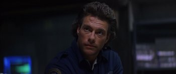 Movie still from “Timecop” (1994), directed by Peter Hyams – A person wearing a blue shirt; Close Up shot, Low angle