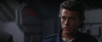 Movie still from “Timecop” (1994), directed by Peter Hyams – A person wearing a jacket; Close Up shot, Over the shoulder angle