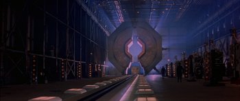 Movie still from “Timecop” (1994), directed by Peter Hyams – A train station that has a train on the tracks; Extreme Wide shot, Low angle