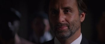 Movie still from “Timecop” (1994), directed by Peter Hyams – A person wearing a suit and tie; Close Up shot, Over the shoulder angle