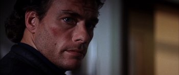 Movie still from “Timecop” (1994), directed by Peter Hyams – A man's face in the dark; Close Up shot, Low angle