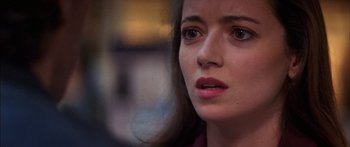 Movie still from “Timecop” (1994), directed by Peter Hyams – A woman's face looking at the camera; Close Up shot, Over the shoulder angle