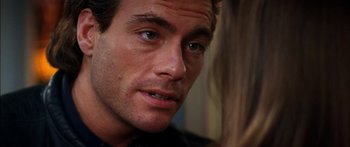 Movie still from “Timecop” (1994), directed by Peter Hyams – A person looking at the camera; Close Up shot, Over the shoulder angle