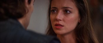Movie still from “Timecop” (1994), directed by Peter Hyams – A woman's face looking at the camera; Close Up shot, Over the shoulder angle
