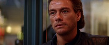 Movie still from “Timecop” (1994), directed by Peter Hyams – A man's face as he stares into the distance; Close Up shot, Over the shoulder angle