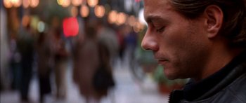 Movie still from “Timecop” (1994), directed by Peter Hyams – A man's face in a city street; Close Up shot, Over the shoulder angle