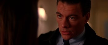 Movie still from “Timecop” (1994), directed by Peter Hyams – A person wearing a suit and tie; Close Up shot, Over the shoulder angle